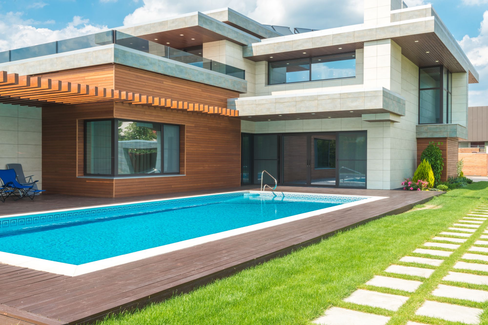 Modern home with a sunlit pool and garden